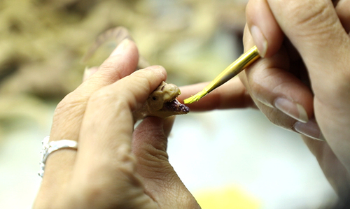 Old craftsman with more than 10 years of experience, hand coloring Old craftsman with more than 10 years of experience, hand coloring